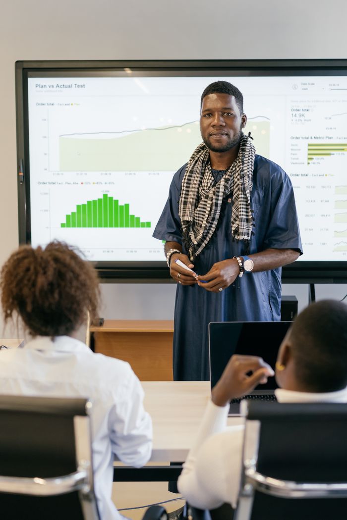Business professional presenting data analysis in modern office setting.